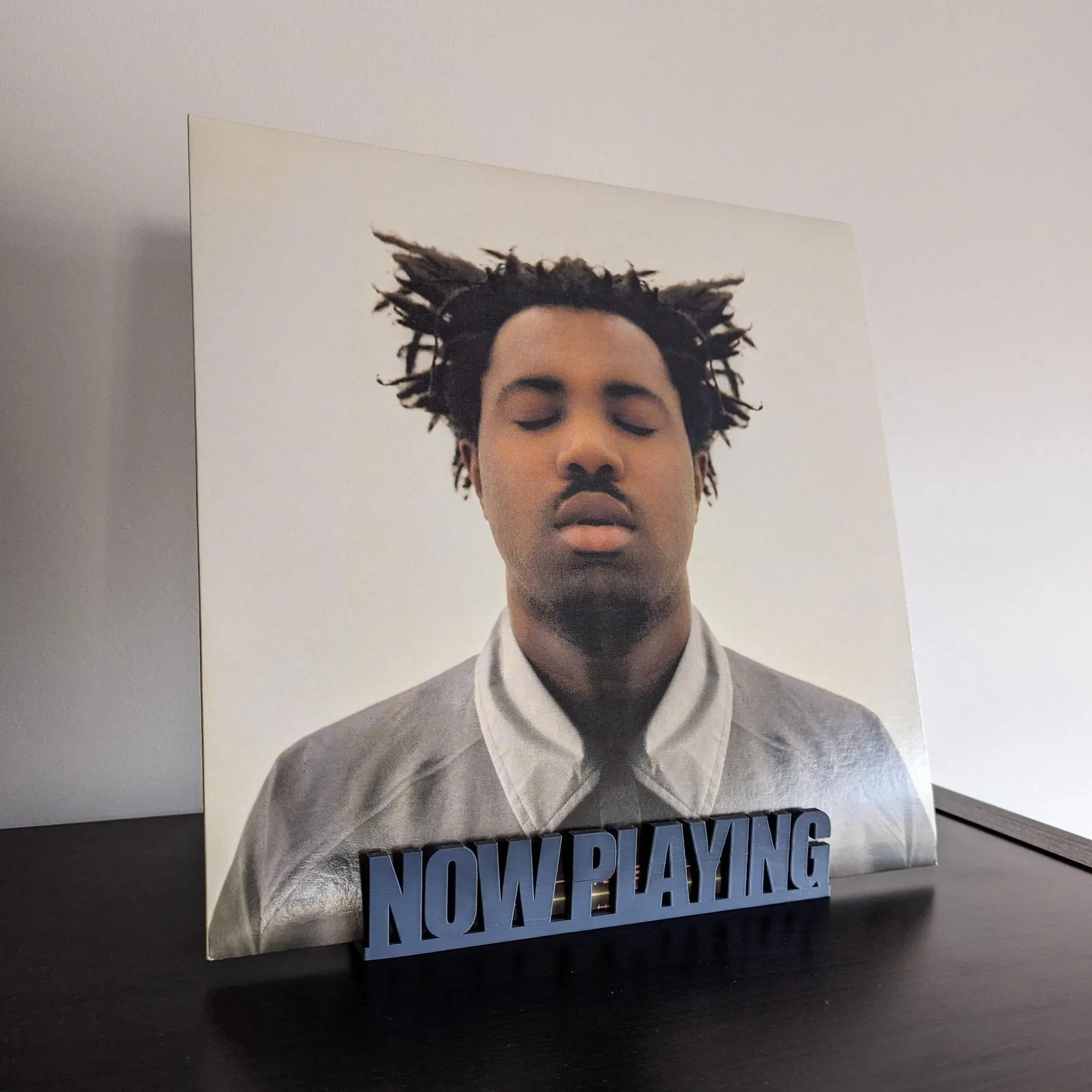 Rekkid Now Playing stand on a desk