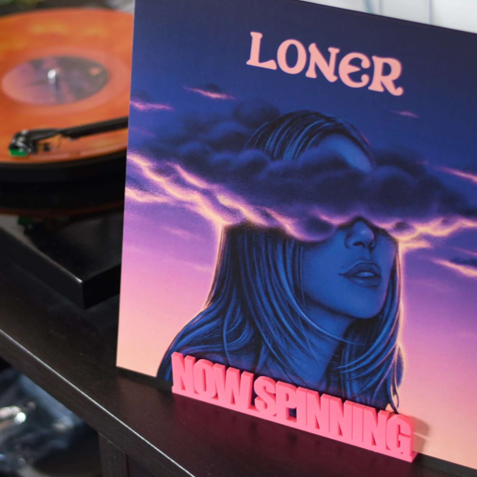 Rekkid Now Spinning stand next to a turntable