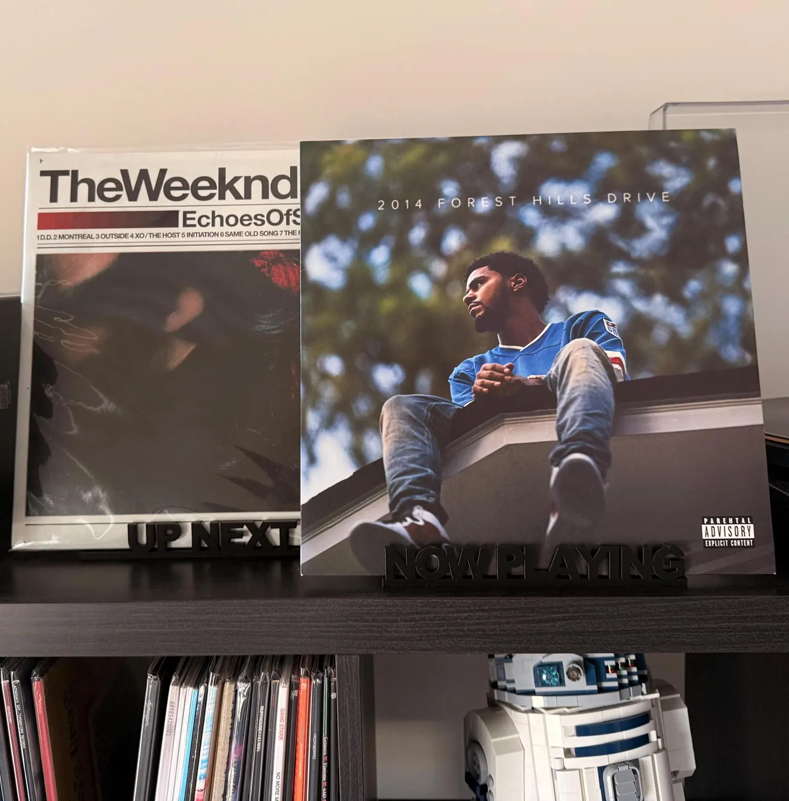 Rekkid Up Next and Now Playing stands on a shelf